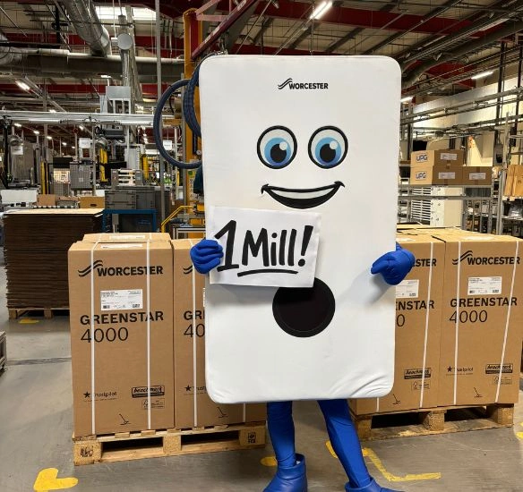Bobby the boiler holding sign that says 'one million' in front of boilers